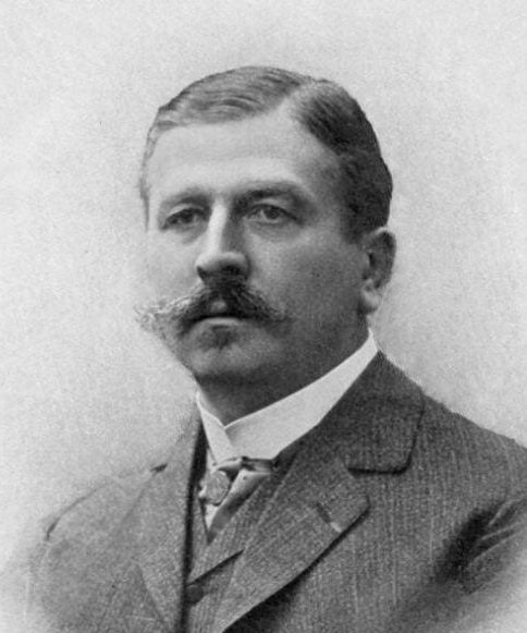 Joseph Babinski, a man with hair parted on the side and a sizeable mustache in a suit. Namesake of Babinski's sign.