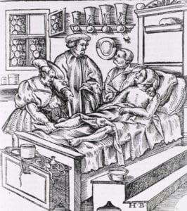 A physician at the bedside of a patient