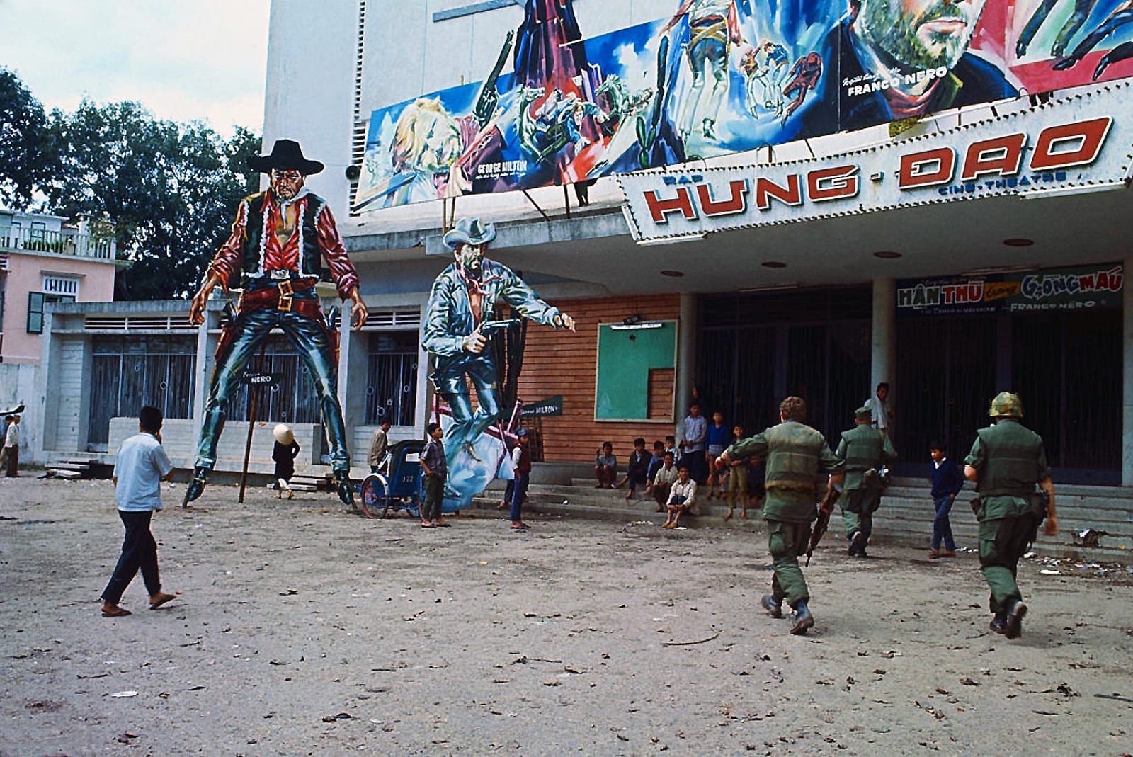US Marines approach a theater with Western figures outside it