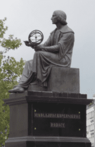 Nicolaus Copernicus holding a heliocentric model of the solar system in Warsaw, Poland