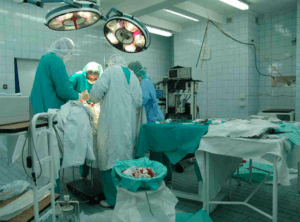 operating room with surgeons hard at work on a patient