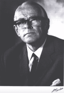 Denis Burkitt, a man in glasses and a suit