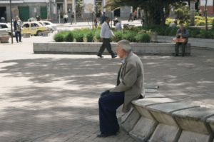Elderly man sitting alone in park