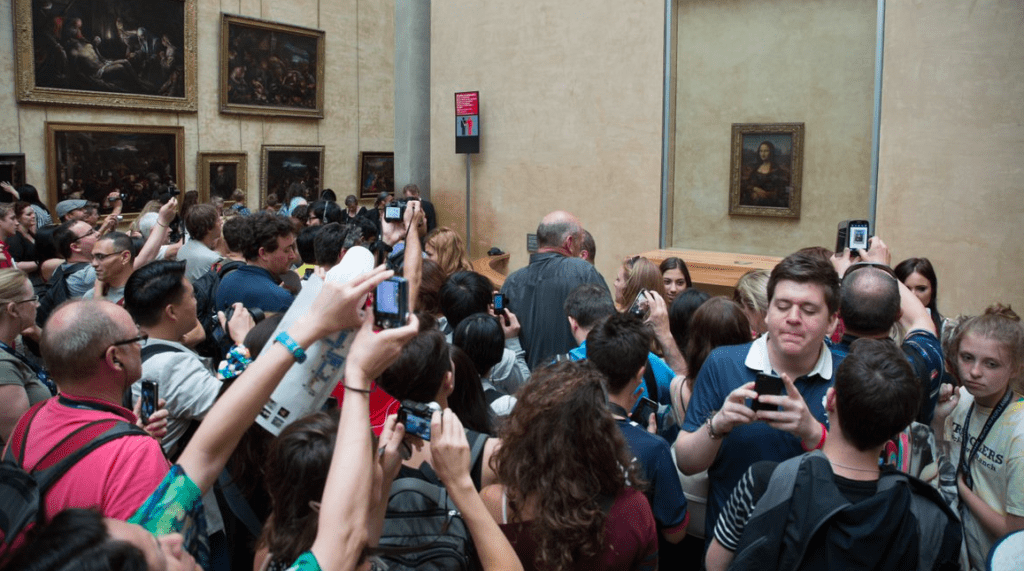 People taking photos of the Mona Lisa. Mona Lisa's smile may have had a medical cause such as pregnancy or illness