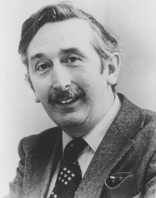 Godfrey Hounsfield, smiling man with mustache and patterned necktie, who invented the CT scanner. Photo for article on history of CT scanner and history of CT scan