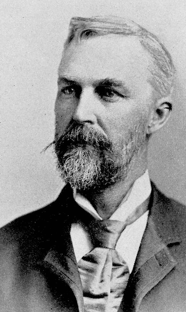 George Huntington of Huntington's disease or Huntington's chorea. Huntington is depicted as a man with a bushy beard in a suit and tie.