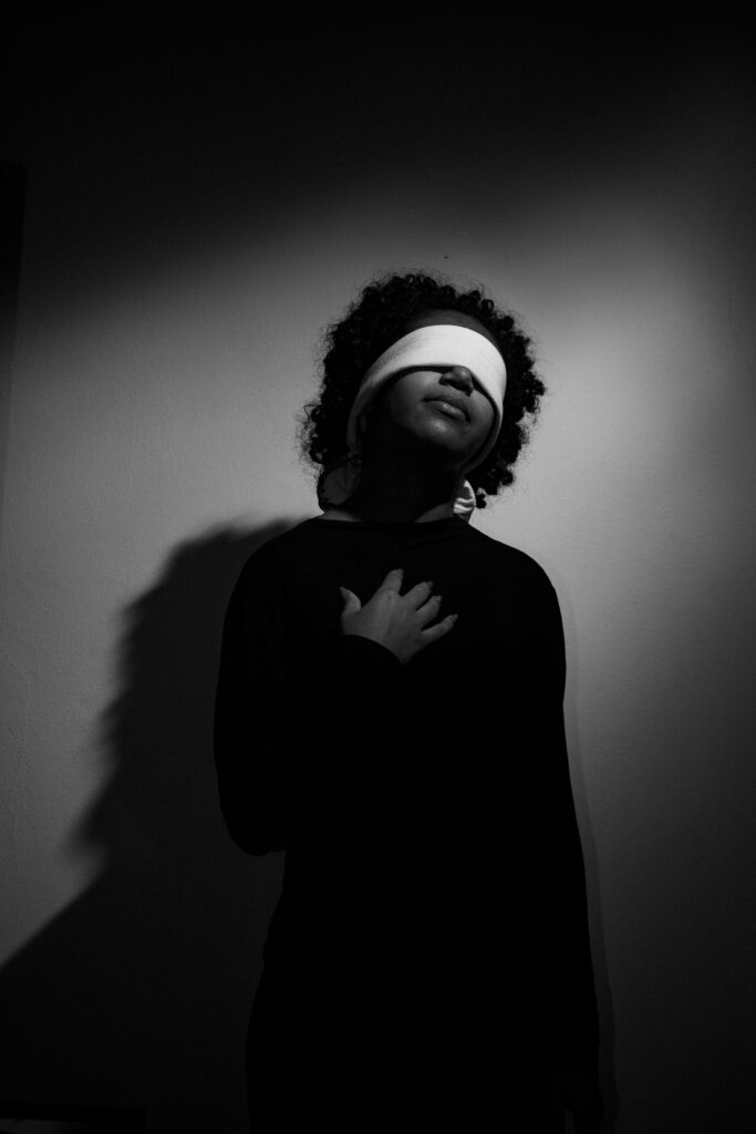 Black and white photo of woman wearing blindfold